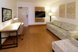 a living room with a couch and a desk at Wyndham Garden McAllen at La Plaza Mall in McAllen