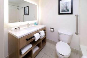 a bathroom with a white toilet and a sink at Wyndham Garden McAllen at La Plaza Mall in McAllen