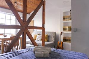 a room with a bed and a table with a guitar at Lisboa - Apartment with Garden - Ajuda Palace & Royal Treasure Museum in Lisbon
