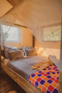a bed with a canopy in a room at Hluhluwe Bush Camp in Hluhluwe +86 photos