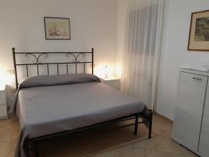 a bedroom with a bed and a dresser in it at Villa Elisa Chia Su Giudeu in Domus de Maria