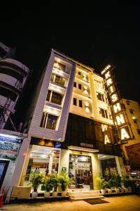 a building with plants in front of it at night at Hotel Krishna - By RCG Hotels in New Delhi