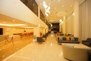 a lobby with couches and chairs in a building at Best Western Premier Dynasty in Addis Ababa