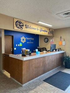 a lobby with a welcome to granville sign on the wall at SureStay by Best Western Glendive Yellowstone River in Glendive