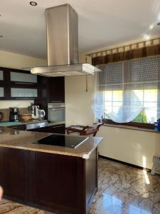 a kitchen with a stove top island in a kitchen at LakeHouse in Giewartów
