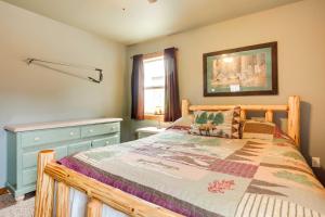 a bedroom with a wooden bed and a window at Pet-Friendly Wisconsin Cabin on Lake with Fire Pit! 