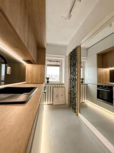 a kitchen with wooden cabinets and a counter top at Genesis - Iasi City Center in Iaşi