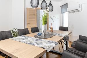 a dining room with a table and chairs at Vila Maria in Vinkovci