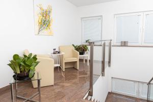 a living room with chairs and a table at Vila Maria in Vinkovci +12 photos