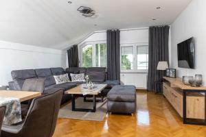 a living room with a couch and a table at Vila Maria in Vinkovci