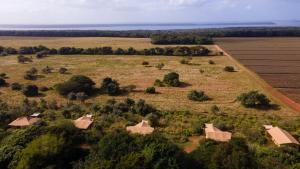 an aerial view of a farm with buildings in a field at Hluhluwe Bush Camp in Hluhluwe