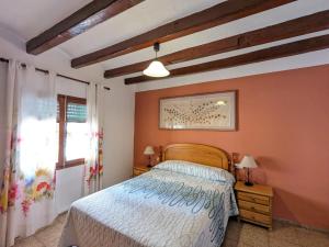 a bedroom with a bed and a window at Casa rural- Casa Liberta in Canet lo Roig