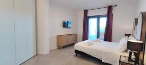 a bedroom with a white bed and a window at Marisabella Suite Spa 5 in Bari