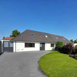 a large white house with a driveway at Stylish 4 Bed, newly renovated home in Nottingham in Nottingham