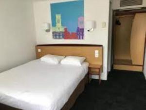 Postel nebo postele na pokoji v ubytování Kyriad Direct Nancy Est - Essey