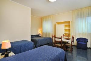Postel nebo postele na pokoji v ubytování Hotel & Residence Dei Duchi
