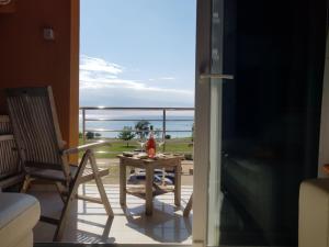 a balcony with a table and a view of the ocean at Apartments Fontana Zambratija in Zambratija