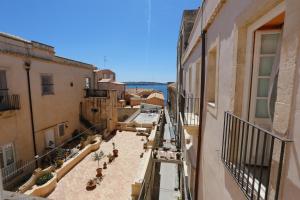 a view of an alley from a balcony of a building at Casa Maiorca in Siracusa