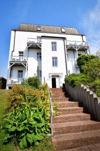 a white house with stairs in front of it at Hamburg-App-08 in Ahlbeck