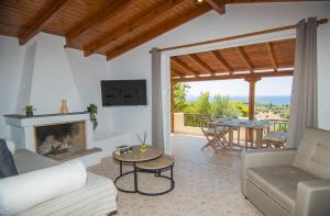 a living room with a couch and a fireplace at Blue Sea View Prime Apartment, Porto Heli in Porto Heli