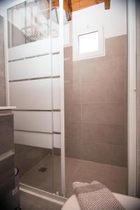 a shower with a glass door in a bathroom at Blue Sea View Prime Apartment, Porto Heli in Porto Heli