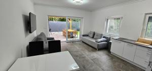 a living room with a couch and a table at Vécsey House Zamárdi in Zamárdi