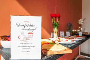 a table with a sign for a breakfast table in the end at Spinola Stays in St. Julianʼs