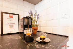 a coffee maker and two glasses on a table at Spinola Stays in St. Julianʼs