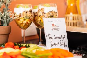 a table with two wine glasses and some food at Spinola Stays in St. Julianʼs