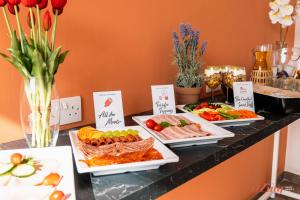 a buffet with several plates of food on a counter at Spinola Stays in St. Julianʼs