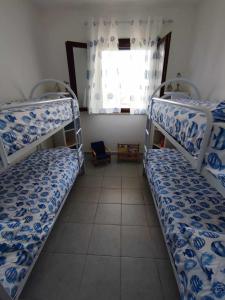 two bunk beds in a room with a window at Porto Selvaggio Casa Zaffiro in Torre Inserraglio