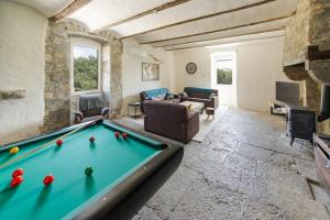 a large living room with a pool table at Le Mas pierre et soie in Labeaume
