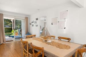 a dining room with a wooden table and chairs at Gretel Cl 4 Nelson Bay in Nelson Bay