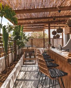 a bar with chairs and tables on a patio at Piperaki Project in Naousa