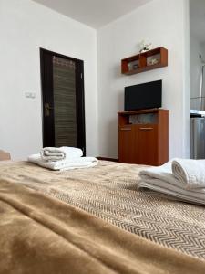 a large bed with two towels on top of it at Apartments Fat e Jet in Ulcinj