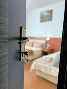 a door with a door knob in a bedroom at Apartments Fat e Jet in Ulcinj