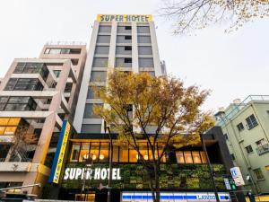 a building with a sign on top of it at Super Hotel Tokyo Kinshicho Ekimae / Vacation STAY 78889 in Tokyo