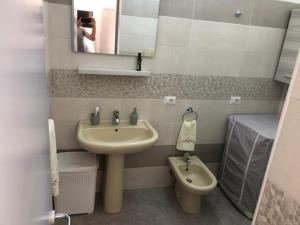 a small bathroom with a sink and a toilet at CASA DIANA in Lipari +3 photos