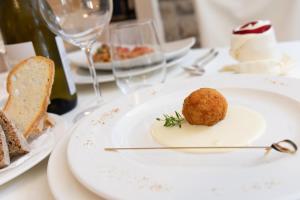 a white plate with a dessert on a table at Hotel Rosmarina in Marina di Grosseto