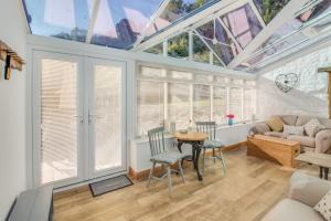 a living room with skylights and a table and chairs at The Mill Nant Alyn in Rhydymwyn