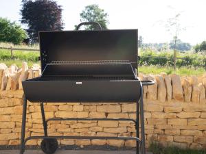 a grill sitting in front of a brick wall at Pass the Keys Chestnut Cottage parking stunning views in Chipping Campden