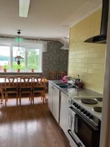 a kitchen with a sink and a stove top oven at Karaby Gård, Country Living självhushåll in Kristinehamn