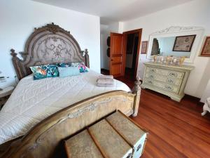 a bedroom with a large bed and a dresser at Villa Castello in Bodrum City