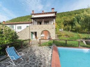 a villa with a swimming pool and a house at Lovely Holiday Home with private pool in San Marcello Pistoiese