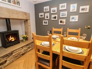 a dining room with a table and a fireplace at 15 Market Place in Barnard Castle