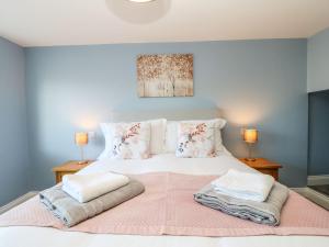 a bedroom with a large white bed with two lamps at 15 Market Place in Barnard Castle