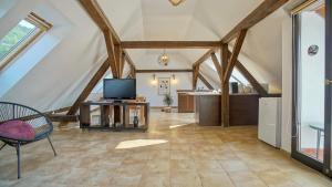 a living room with a tv on a table in a attic at Rooftop proprety with Large Terrace & Stunning Views - Brașov in Braşov