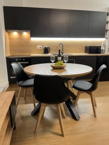 a kitchen with a table and chairs in a kitchen at Apartmány Kyjov in Kyjov