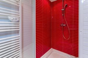 a red tiled shower in a white bathroom at Le Plein Sud Terrasse vue mer Agay in Saint-Raphaël +14 photos
