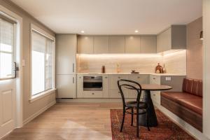 a kitchen with a table and a chair and a couch at Oakview in Hanmer Springs